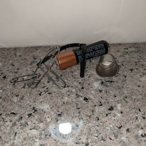 A thimble a battery and others pictured.